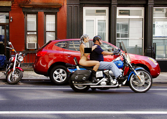 Photographer Erica Simone on the back of a motorcycle