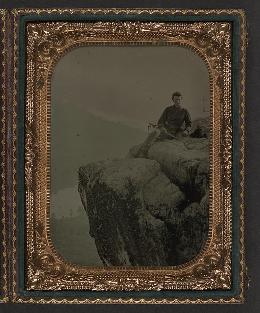 Civil War soldier sitting on a cliff